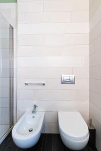 a bathroom with a toilet and a sink at Casa Monet 41 in Saint Vincent +38 photos