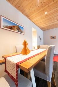 a dining room with a wooden table and chairs at Casa Monet 41 in Saint Vincent