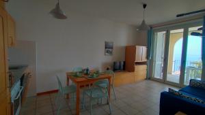 a kitchen and dining room with a table and chairs at TRILOCALE DIRETTAMENTE SUL MARE- cod 511 in Porto Recanati