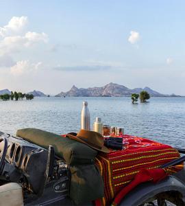 a table with a hat sitting on top of the water at Chandras palace hotel kothar in Kothār