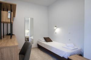 a small bedroom with a bed and a chair at Olevia Comfort in Faliraki +63 photos