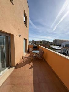 a balcony with a table and chairs on a building at Apartament Deportiva in Deltebre