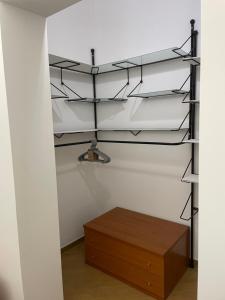 a closet with black shelves and a wooden drawer at Msholiday home in Cinisi