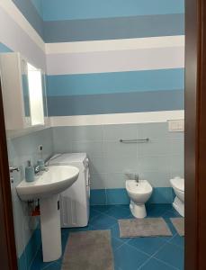 a bathroom with a sink and a toilet at Msholiday home in Cinisi +9 photos