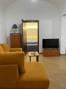 a living room with a couch and a flat screen tv at Msholiday home in Cinisi