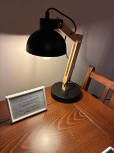 a desk with a lamp and a sign on a table at Studio Almyros in Almiros