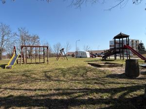 a park with a playground with a slide and swings at Apartament Mazury in Kętrzyn