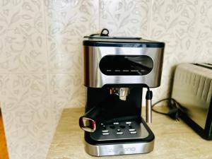 a coffee maker sitting on top of a counter at Nuru House Stone Town Ensuite 3BR Apartment in Zanzibar City