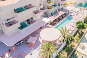 an aerial view of a hotel with a pool and a resort at Paradiso Ibiza Art Hotel - Adults Only in San Antonio Bay +51 photos