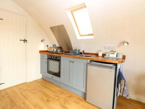 a kitchen with a sink and a stove at Vine View in Halesworth +12 photos