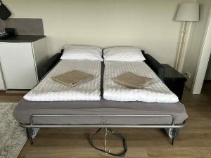 a bed with two pillows on it in a room at Mountain Cabin at Rauðafell in Hvolsvöllur