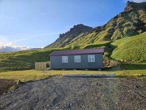a house on the side of a hill at Mountain Cabin at Rauðafell in Hvolsvöllur