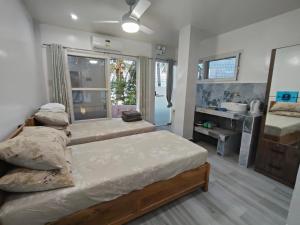 a bedroom with two beds and a window at Mountain Meets The Sea Hidden Resort in Dauis