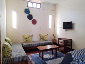 a living room with a couch and a table at Hotel Le Petit Paradis in Antsiranana