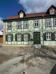 a large green and white building with a door at Ecke - der Romanik in Quedlinburg