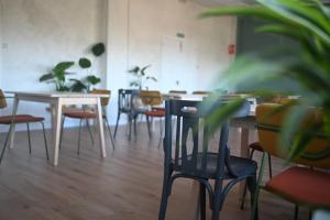an empty room with tables and chairs and plants at A Casa da Toura in Puentedeume