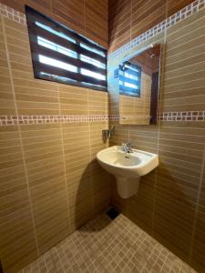 a bathroom with a sink and a mirror at The Golden, Apartrooms in Trivandrum