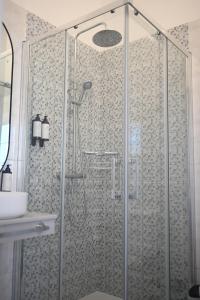 a shower with a glass door in a bathroom at A Casa da Toura in Puentedeume +37 photos