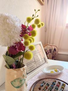 a vase filled with flowers sitting on a table at Gästezimmer Ferienhaus Waldblick in Sonnenbühl