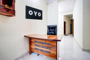 a desk with a chair on a wall at Hotel O Hotel Denmark in Chinhat