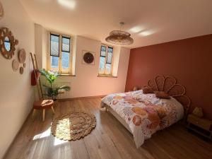 a bedroom with a bed and a rug on the floor at Pause et vous à la mer in Fécamp