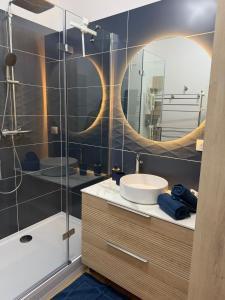 a bathroom with a sink and a mirror at Pause et vous à la mer in Fécamp