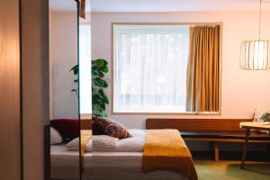 a bedroom with a bed and a window at Nomad Design & Lifestyle Hotel - Member of Design Hotels in Basel +44 photos