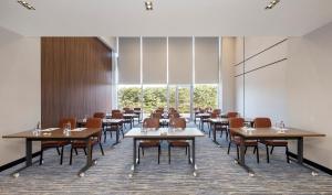 a dining room with tables and chairs and windows at Crowne Plaza Istanbul West-Beylikduzu By IHG in Istanbul
