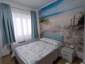 a bedroom with a bed and a painting on the wall at Villa La Lanterna in Pietra Ligure