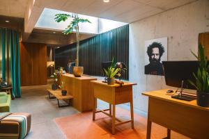 an office with a desk with plants on the wall at Nomad Design & Lifestyle Hotel - Member of Design Hotels in Basel