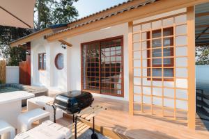 a barbecue on the deck of a house at Tenki poolvilla srisaket in Ban Phia Nam