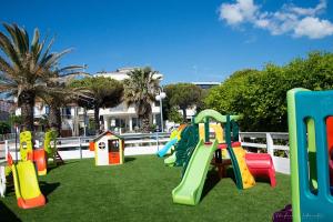 a playground with colorful play equipment on the grass at Holihome Hill View in Tortoreto Lido