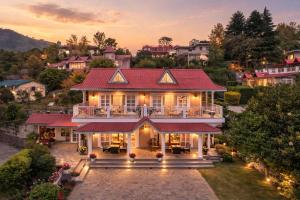 an aerial view of a house with a red roof at Neelesh Inn - Luxury Lake View Resort with Swimming Pool on Bhimtal Lake in Bhīm Tāl