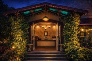 a front door of a house with a chandelier at Neelesh Inn - Luxury Lake View Resort with Swimming Pool on Bhimtal Lake in Bhīm Tāl +6 photos