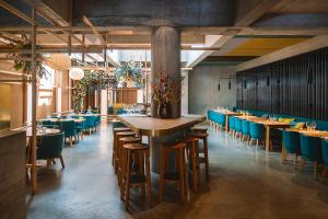 a dining room with a large table and chairs at Nomad Design & Lifestyle Hotel - Member of Design Hotels in Basel