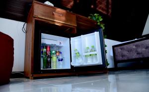 an open refrigerator with drinks inside of it at Infinite cabana in Ella +12 photos