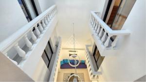 an overhead view of a hallway with stairs and a chandelier at Casa Suspiro in Estepona