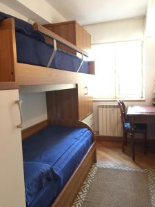 a bedroom with two bunk beds and a desk at Luca Residence in Timişoara