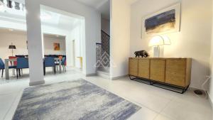 a living room with a wooden cabinet and a dining room at Casa Suspiro in Estepona