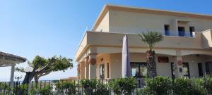 a building with a flag in front of it at I Settembrini in Capo Vaticano +2 photos