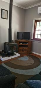 a living room with a fireplace and a tv at Himmel Haus in Laguna