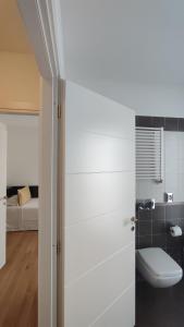 a bathroom with a toilet and a bed at Residence Calissano in Alba +58 photos