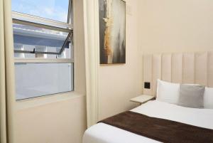 a bedroom with a bed and a window at The City Club in Cape Town +121 photos