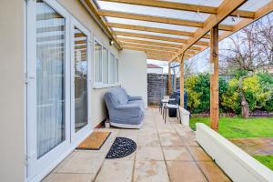 a patio with a chair under a pergola at Smart Studio- North London - Sleeps 2 - free parking in London