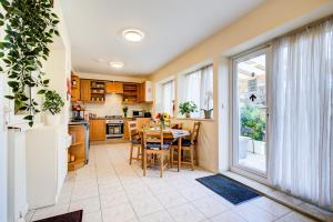 a kitchen and dining room with a table and a window at Smart Studio- North London - Sleeps 2 - free parking in London