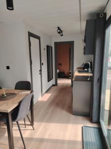 a kitchen and dining room with a table and a table and chairs at Haller Camping in Budapest