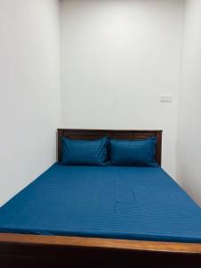 a bed with blue sheets and blue pillows on it at Thew Guest Wilpattu in Nekattegama +22 photos
