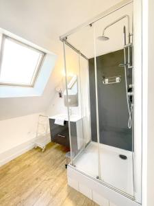 a glass shower in a bathroom with a window at La Chapelle · Vue cathédrale · Chartres centre in Chartres