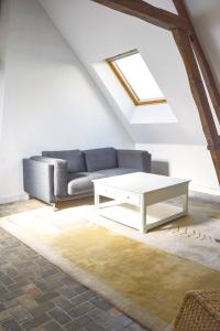 a living room with a couch and a coffee table at La Chapelle · Vue cathédrale · Chartres centre in Chartres +11 photos