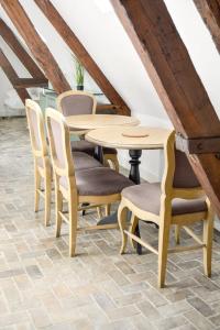 a wooden table and chairs in a room at La Chapelle · Vue cathédrale · Chartres centre in Chartres